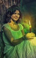 young woman with candle in hands