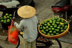 market woman with bike in hanoi