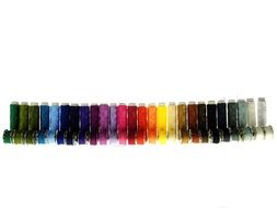 colorful thread spools on a white background