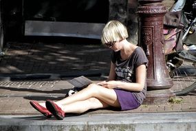 Woman Reading on a street