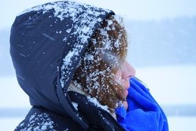 woman in the snowflakes in profile close-up