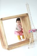cute asian Baby girl photo in wooden frame