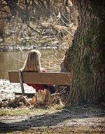 Woman is sitting on the bank