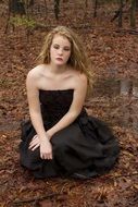 girl in a black dress in the autumn forest