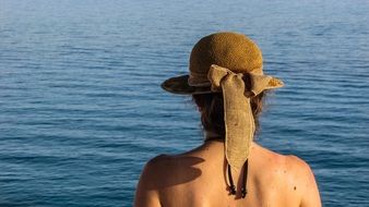 Woman in Hat at Sea, back view