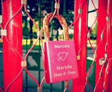 pink padlock on a metal fence