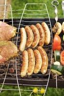 sausages and vegetables on the grill in the summer