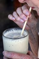 man drinking a milkshake close-up