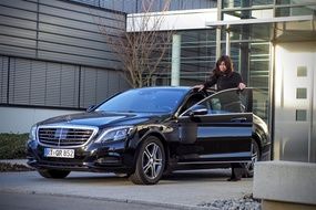 businesswoman in black mercedes