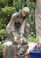 stone statue Woman with flower