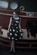 Monochrome picture of girl posing on a railway carriage background