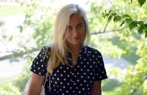 girl with white hair near a green tree