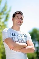 handsome young man in a t-shirt among nature