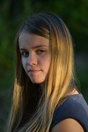 girl posing in the rays of the setting sun