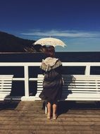 beautiful Woman with Umbrella near the water