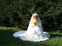 bride with a bouquet on the lawn