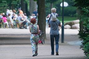 family walks in the park with children