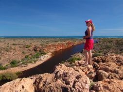 the girl looks down on the australian landscape