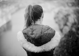 photo of a girl in a jacket with a hood back view