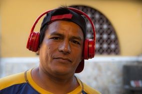 photo of an asian man with red headphones