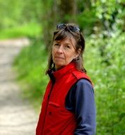 aged woman in red vest