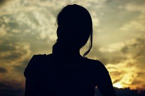 Dark Woman Silhouette at Sunset sky