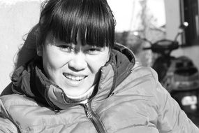 black and white photo of a chinese girl in a jacket
