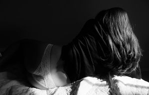 Black and white photo of the lying woman