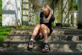 girl in a dress sitting on the stairs