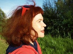 portrait of a woman with windblown red hair