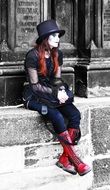 girl sitting on a stone near a building in Prague