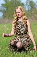 sitting blonde hair woman in a field