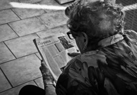 black and white photo of a grandmother with a newspaper