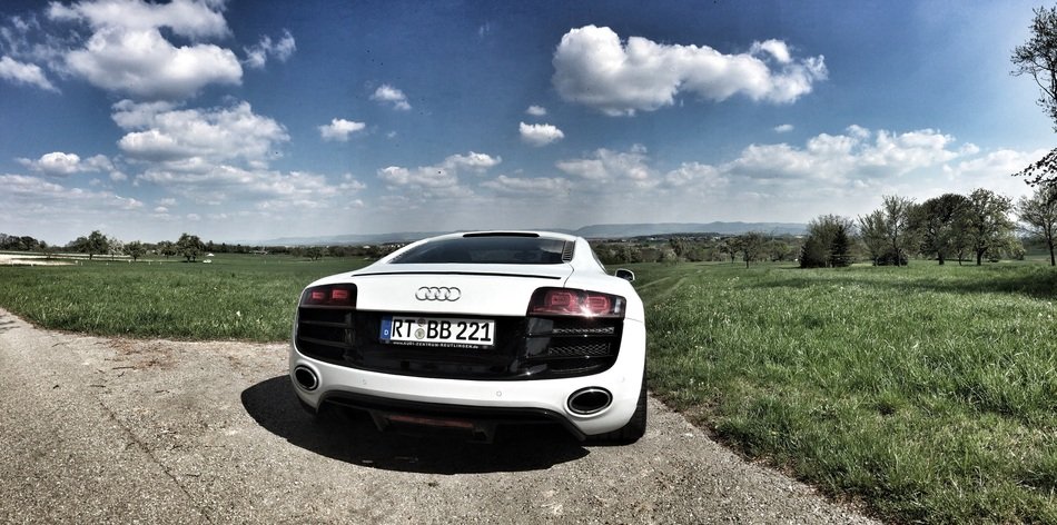 white sports car on the edge of the road