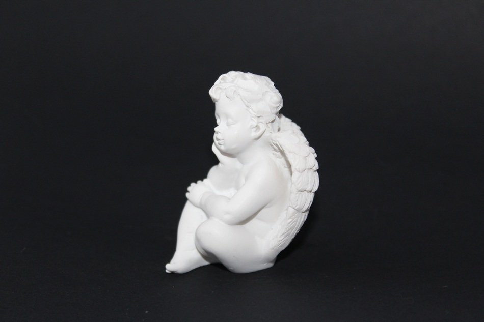 figure of cupid on the black background