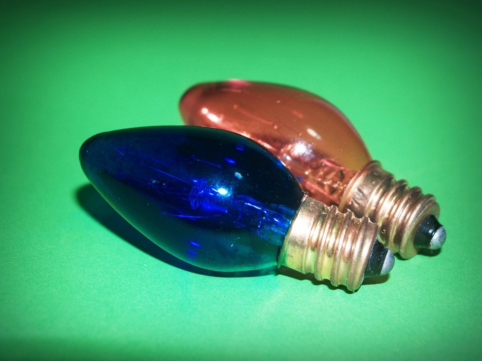 red and blue light bulb on green background