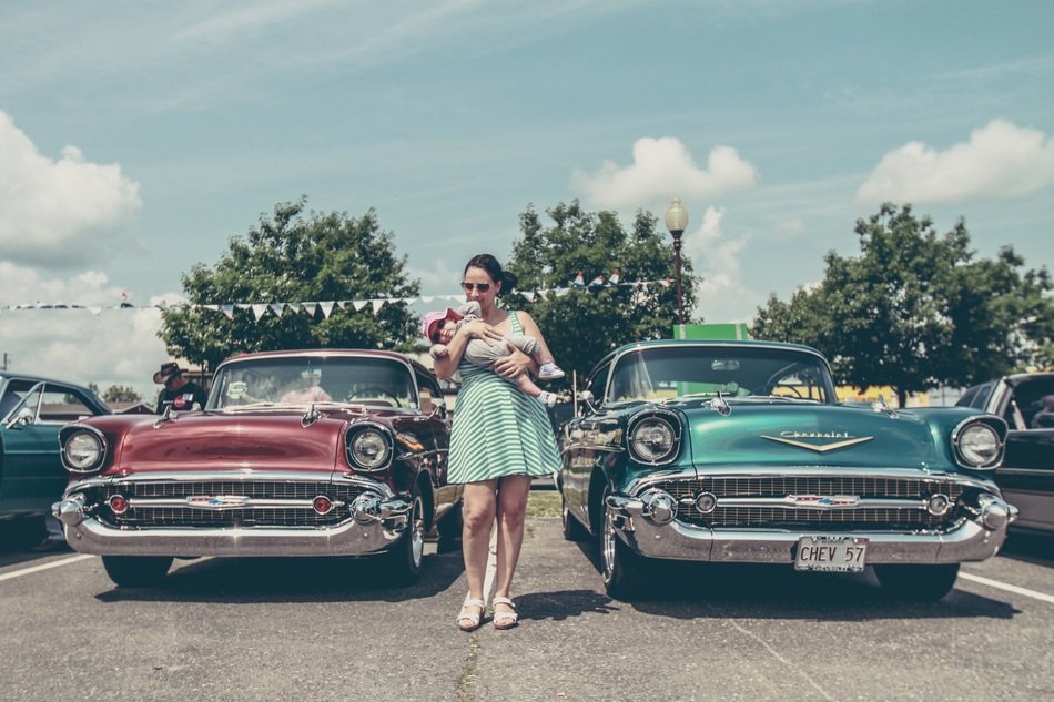 girl with baby on retro car background
