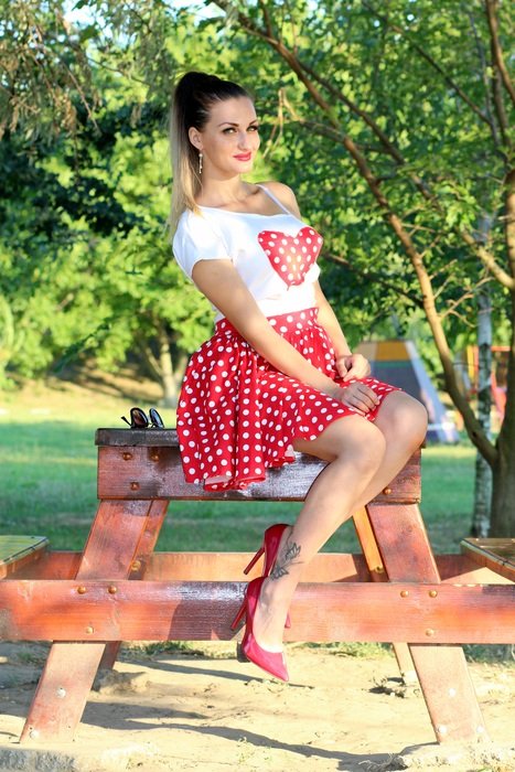 girl in red in white peas in the park