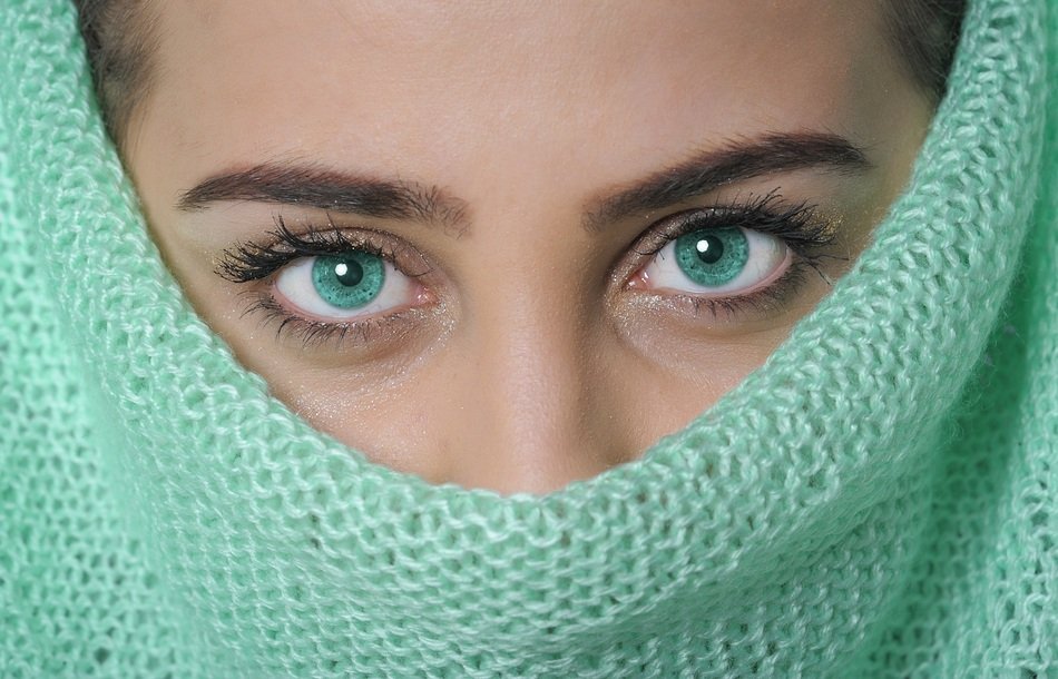 Portrait of the beautiful woman with bright green eyes