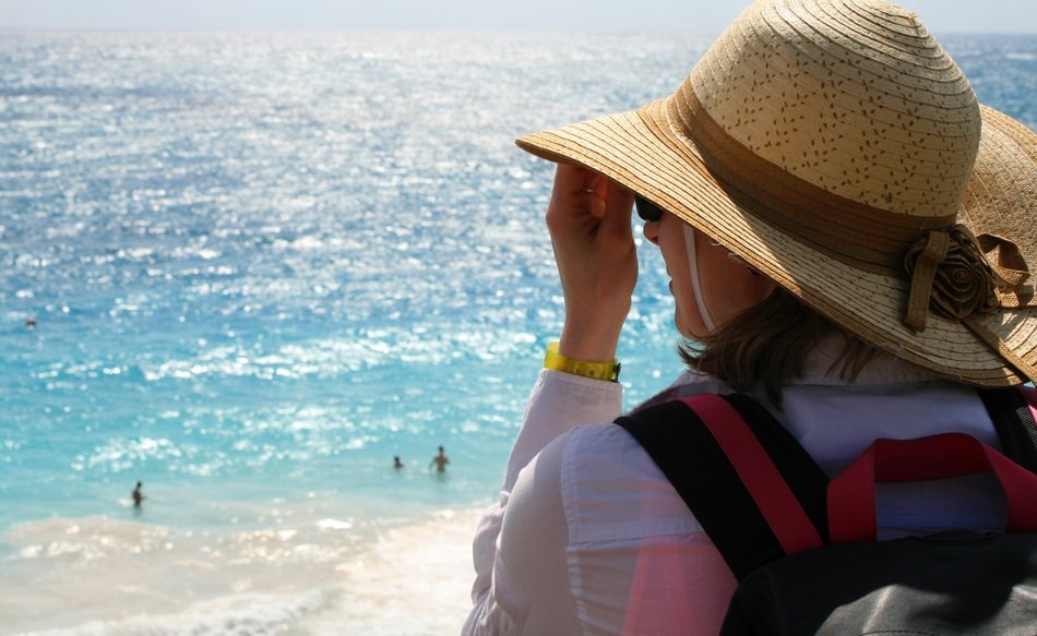 girl in straw hat at ocean