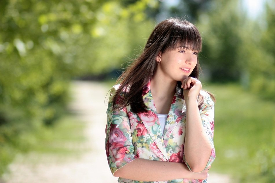 Portrait of the brunette girl in the park