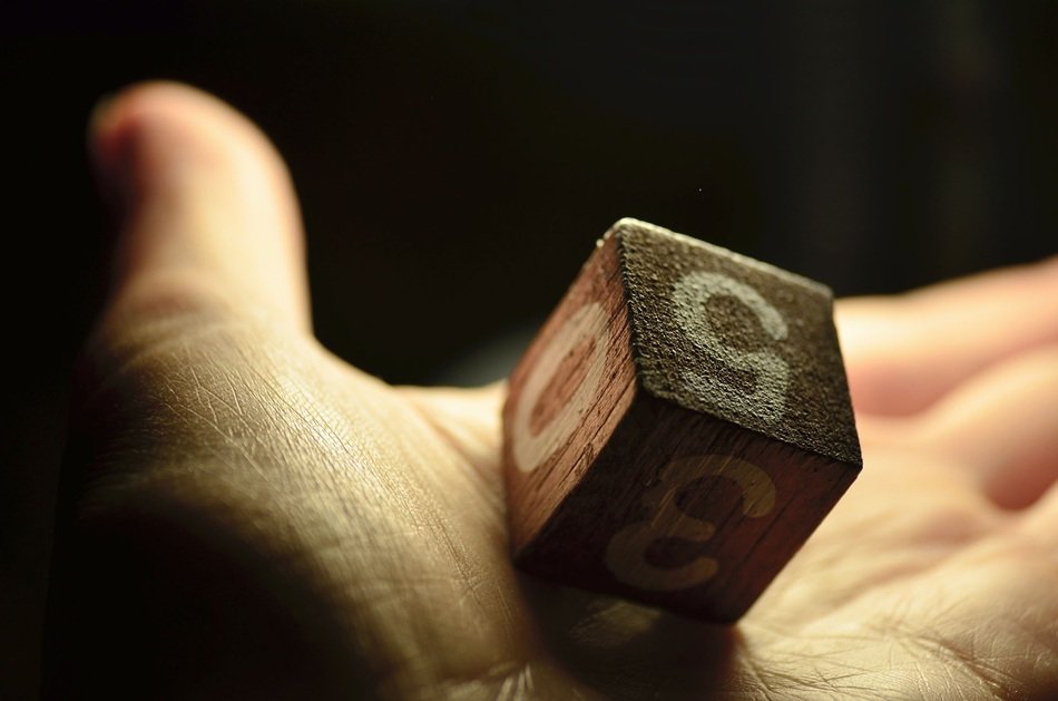 cube with numbers in a manâs hand