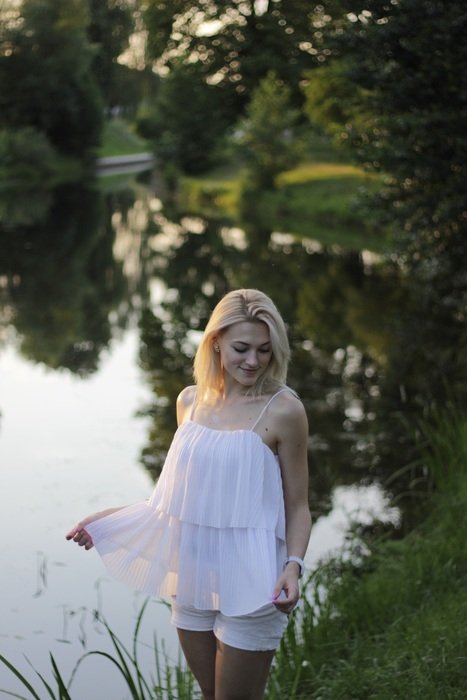 blond woman in park at evening