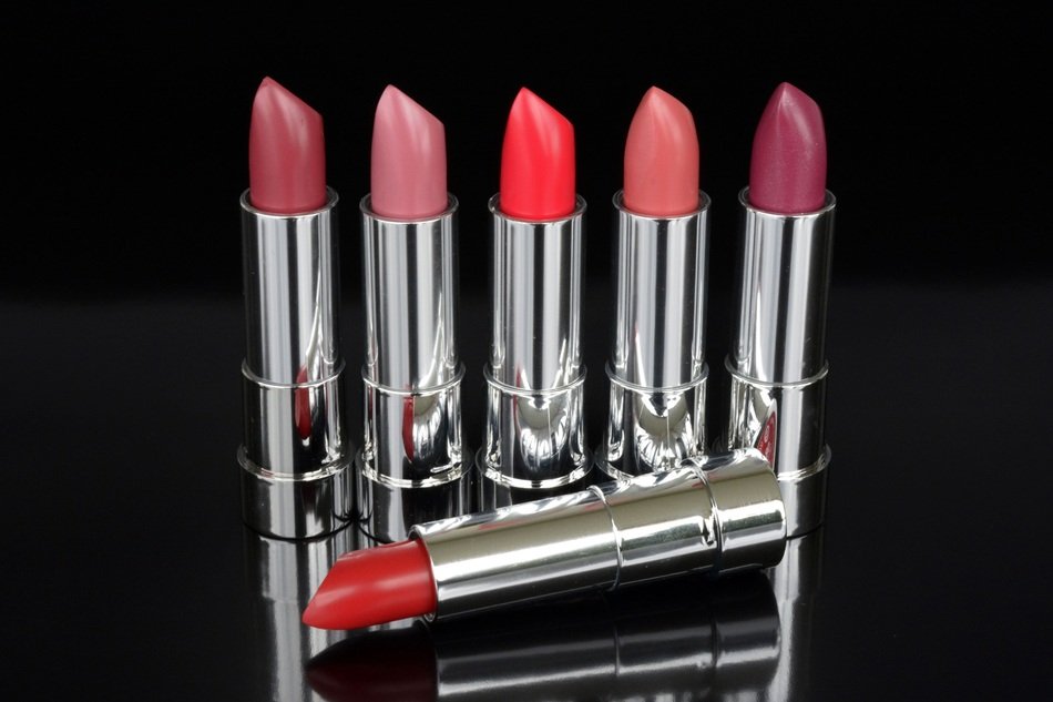 lipstick of different colors on a black background