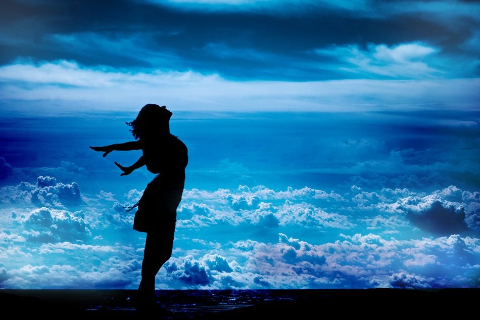 silhouette of a free girl at sea