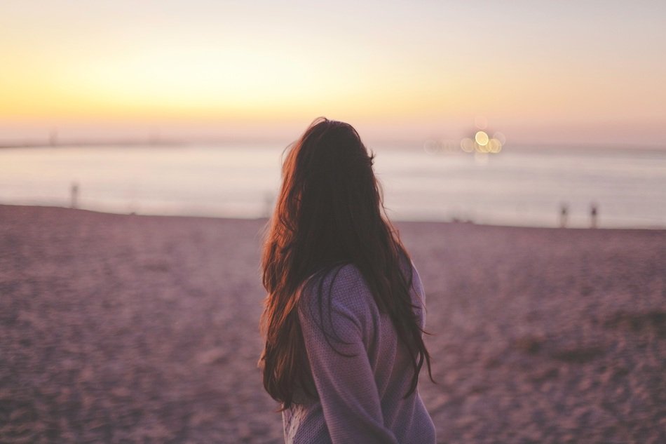 woman on a background of sunset on the beach