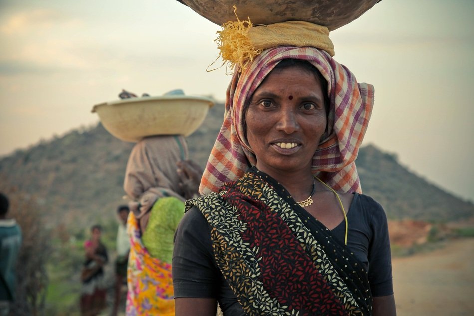 woman with a basket on her head, india