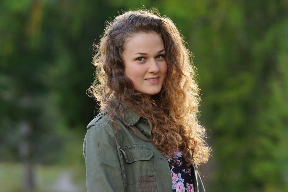 portrait of a girl on a background of green trees