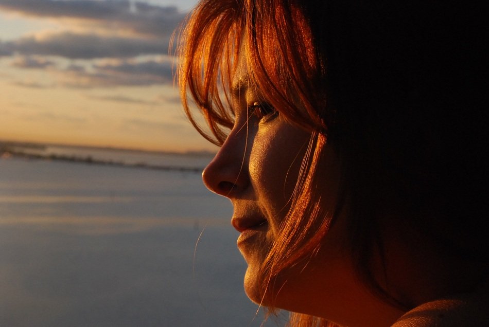 the girl's face in the setting sun
