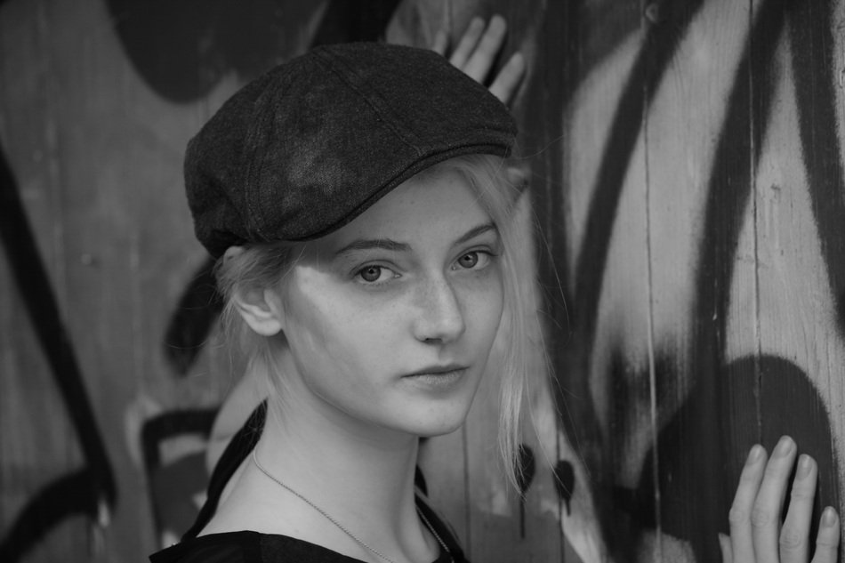 girl in a cap on a background of graffiti